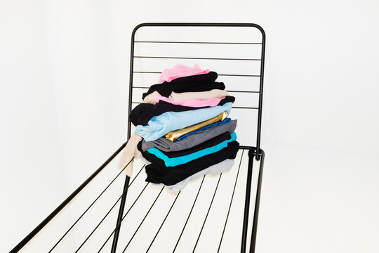 Colourful laundry clothes on a drying rack with direct flashlight