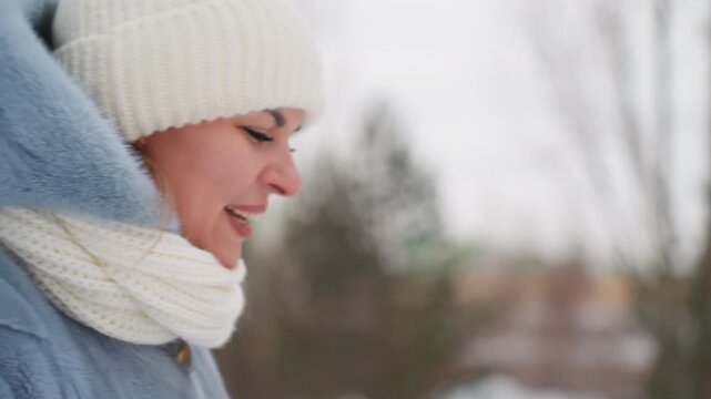 Caucasian woman in winter scarf pensive, closeup profile in snowy urban courtyard with brick apartment backdrop, knit beanie and wool coat, visible breath, muted cold light, thoughtful expression