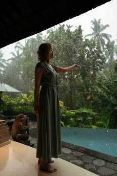 Pouring Rain Invites Reflection Beside Tropical Pool