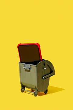 close view of a smartphone in an open gray trash bin