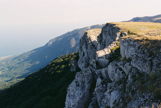 View of mountains and sea in the distance in golden light at summer.