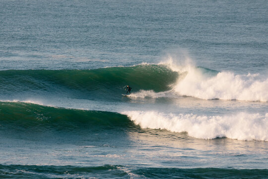 Experienced surfer riding large waves in Anchor Point, Agadir, Morocco