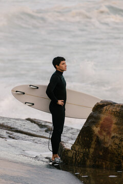 A surfer mentally preparing himself before entering the waves