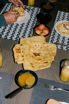 Close-up lit with flash of unknown friends enjoying Moroccan breakfast