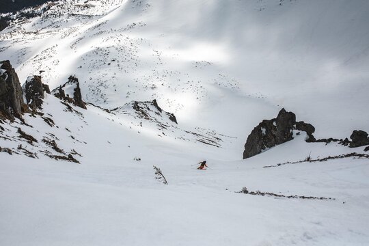 Ski tourer riding  on a sunny winter day in a mountains.