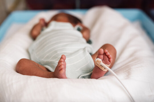 Newborn baby receiving hospital medical care monitoring heart rate