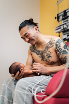 Father enjoying skin to skin with newborn in hospital