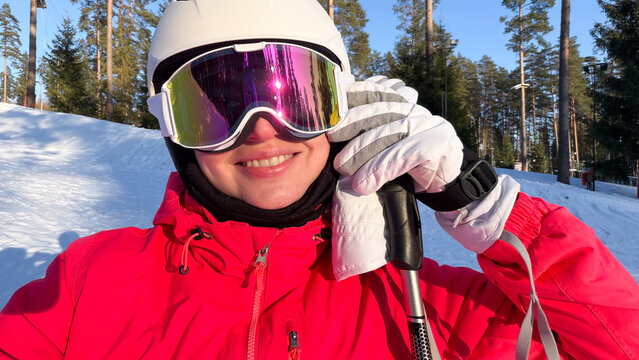 Smiling Woman in Ski Gear on Snowy Slope
