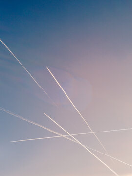 Crossed Paths - Intersecting Vapor Trails on Blue Sky