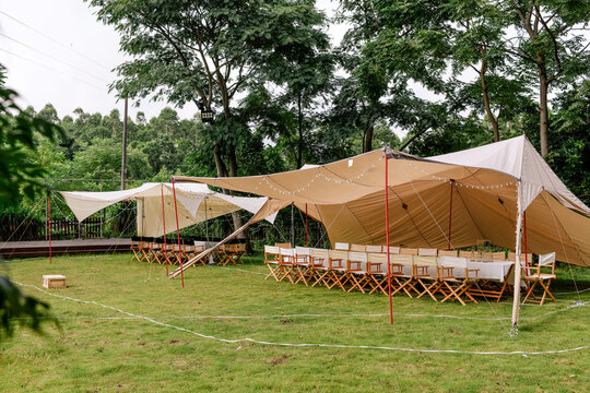 Large dining table set up on a rural outdoor lawn