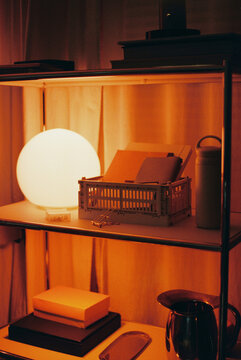 Glowing lamp and storage crate on shelf film photo
