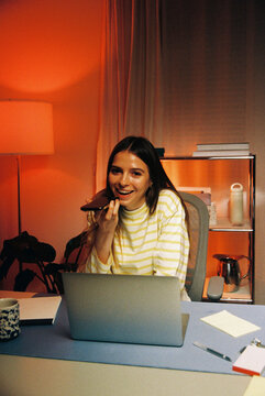 woman speaking on the phone at her home workspace, film photo