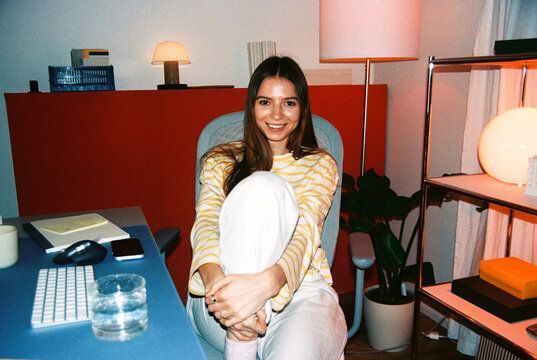 Portrait of a woman in a red home office, film photo