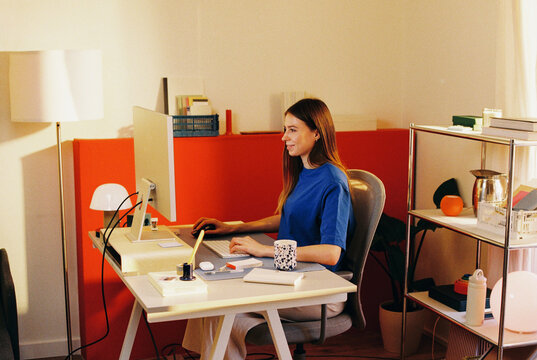 Woman working at desk in home office film photo