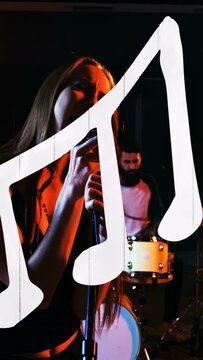 Vertical video: Female singer gripping mic, singing and causing white note overlay, showing music