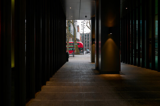 View of a Street and a Red Bus From a Building Corridor in London