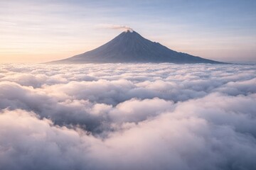 Fototapeta premium Majestic volcanic mountain peak emerging from fluffy clouds at sunrise with golden light