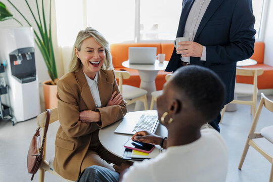 Professionals networking and collaborating in informal office setting