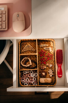 Well-organized storage of hair accessories in a girl's desk.