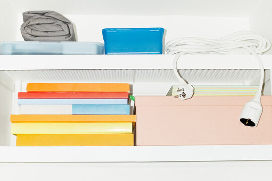 A shelf filled with colourful everyday life objects with flashlight