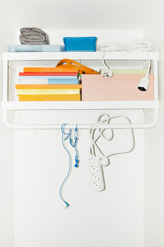 A shelf filled with colourful everyday life objects with flashlight