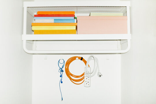 A shelf filled with colourful everyday life objects with flashlight