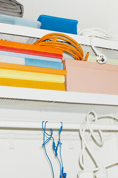 A shelf filled with colourful everyday life objects with flashlight