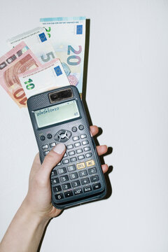 Person calculating money, savings and finances with math calculator