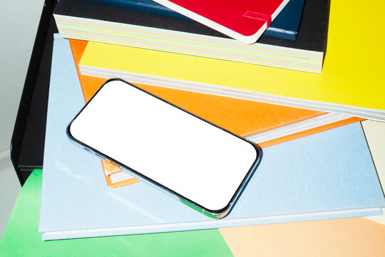 Phone mockup with empty screen for text or design on a office desk