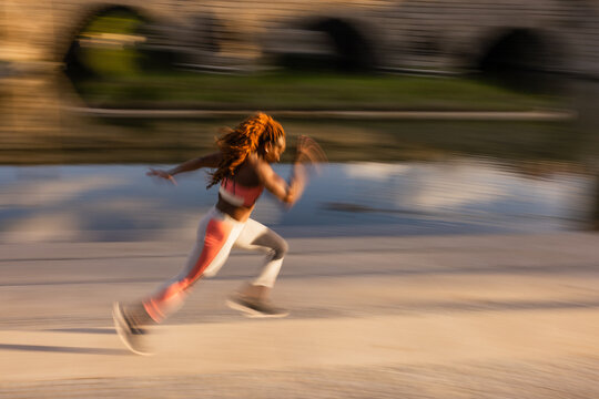 Runner in motion captured in Madrid Rio landscape