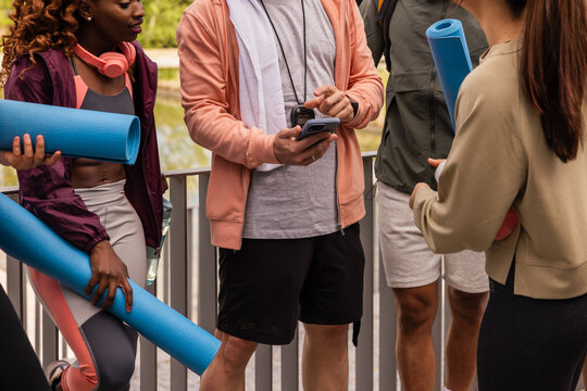 Multiethnic group with exercise mats in outdoor workout