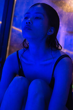 Portrait of calm asian woman in blue light