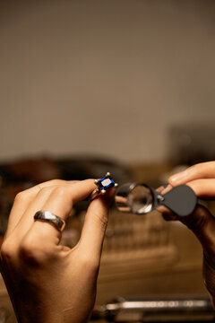 jeweler evaluating ring in workshop, closeup