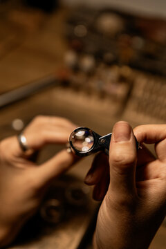 jeweler evaluating ring in workshop, closeup