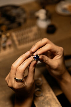 jeweler evaluating ring in workshop, closeup