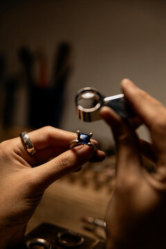 jeweler evaluating ring in workshop, closeup