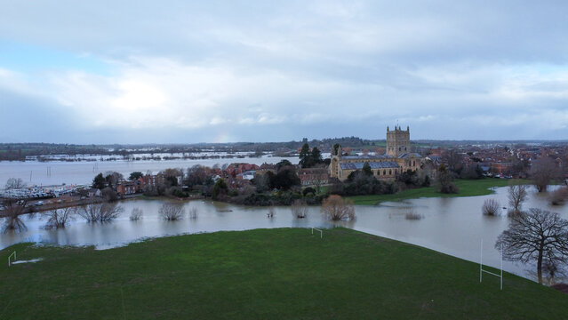 An aerial shot of an abbey surrounded by flood waters