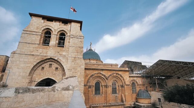 Parter superior of the Holy Sepulchre waving a flag and the windows that have protected the staircase for more than 60 years