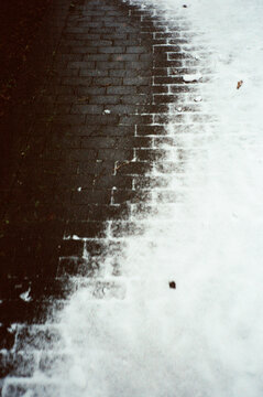 Abstract contrast between brick pavement and snow