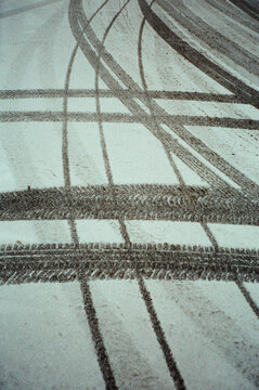 Tire tracks on fresh snow surface.