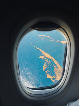 View of Water and sargasso From Airplane Window During Flight