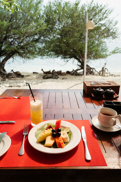 Enjoying a Tropical Breakfast by the Beach Under Sunny Skies