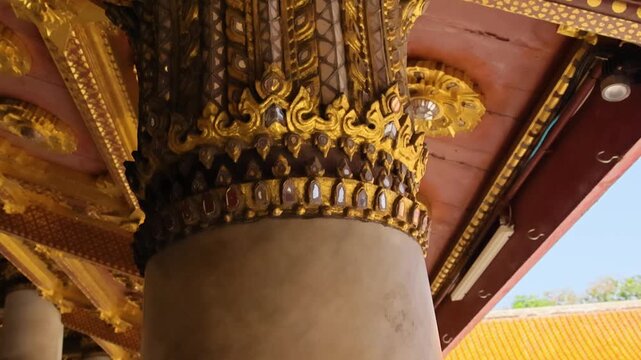 Ornate golden column capital and ceiling medallions, temple detail