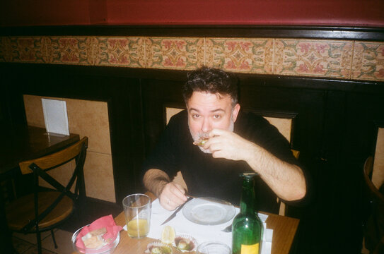 Candid Moment Of Man Enjoying Spanish Tapas