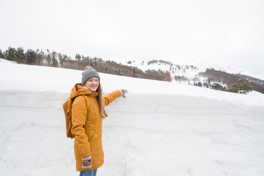 Woman Showing Snow Levels in Mountainous Region Of Spain