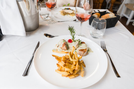 Delicious Pork Tenderloin With Fries at a Restaurant 