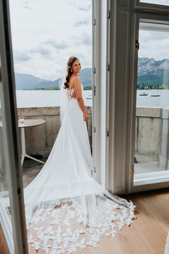 Bride standing in open doorway with lake and mountain view