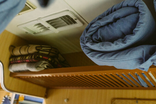 A train sleeping compartment with blankets.