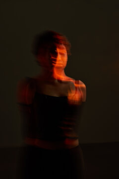 Dancer performing in low light during an art event in a gallery