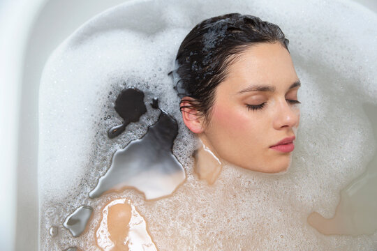 Beautiful woman relaxing in the bath tub